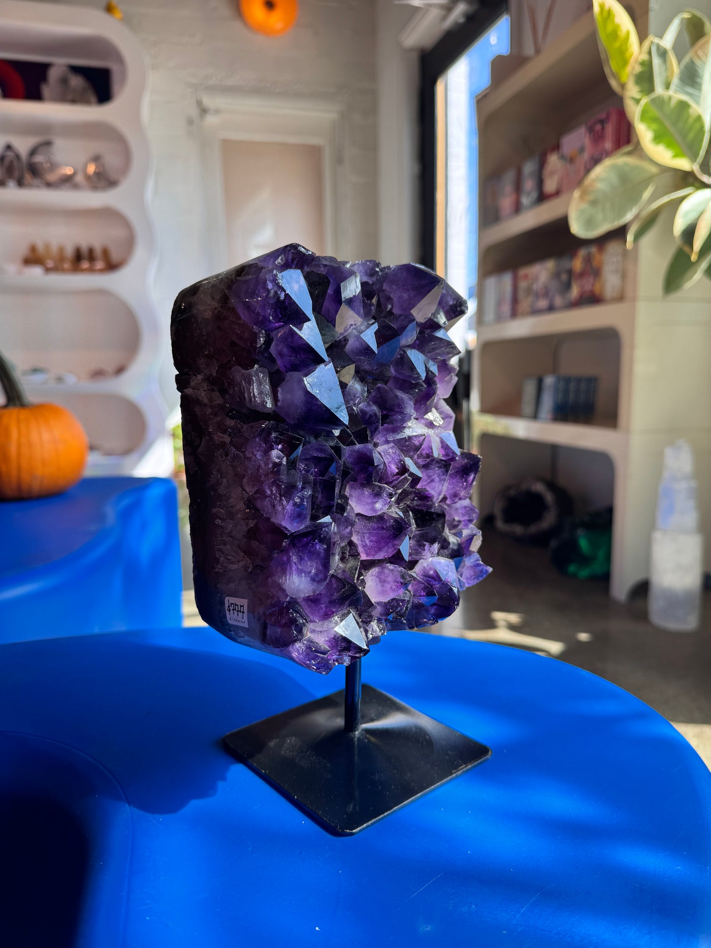 Large amethyst cluster on stand
